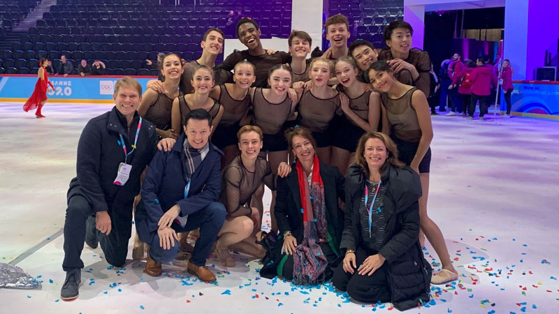 Students and teachers on stage at the youth winter olympics