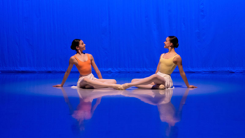 Two students sat on the floor during the 2019 kenneth macmillan emerging choreographer performance