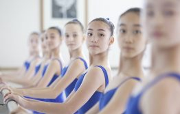 Girls stood at the barre in white lodge studio