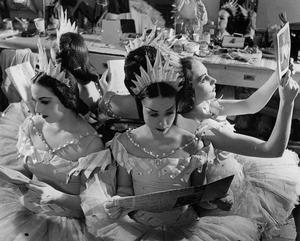 Pauline wadsworth, dorothea zaymes, and jean stokes in the corps de ballet dressing room at the royal opera house in costume as stars for cinderella.