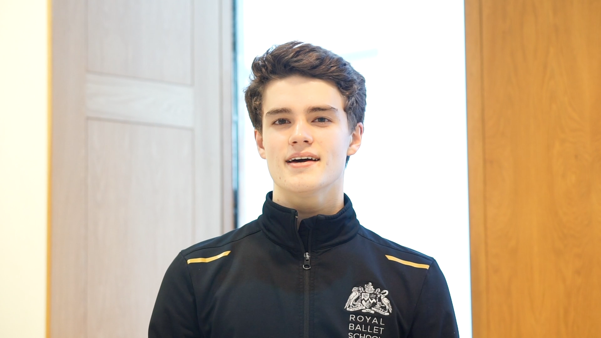 Screen shot from a video of a student talking directly to camera in their school uniform