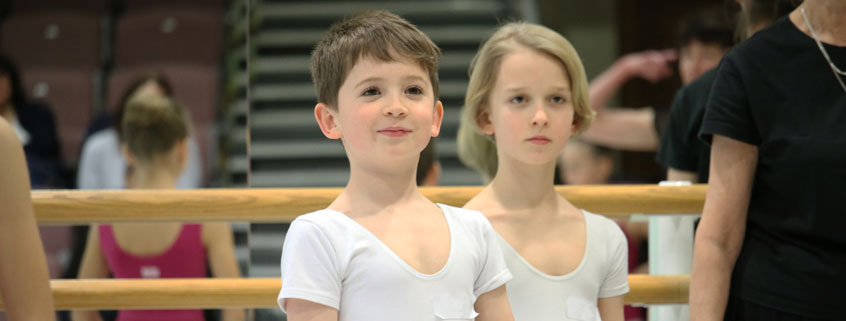 Two young boys smiling in a junior associate insight day ballet class