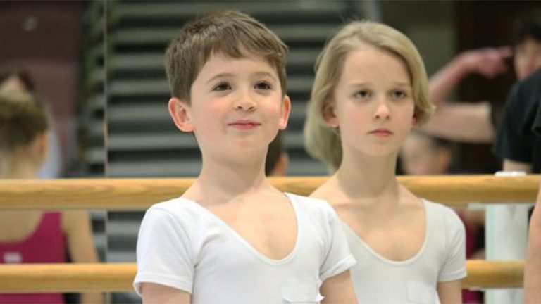 Junior associate in white top smiling at the camera