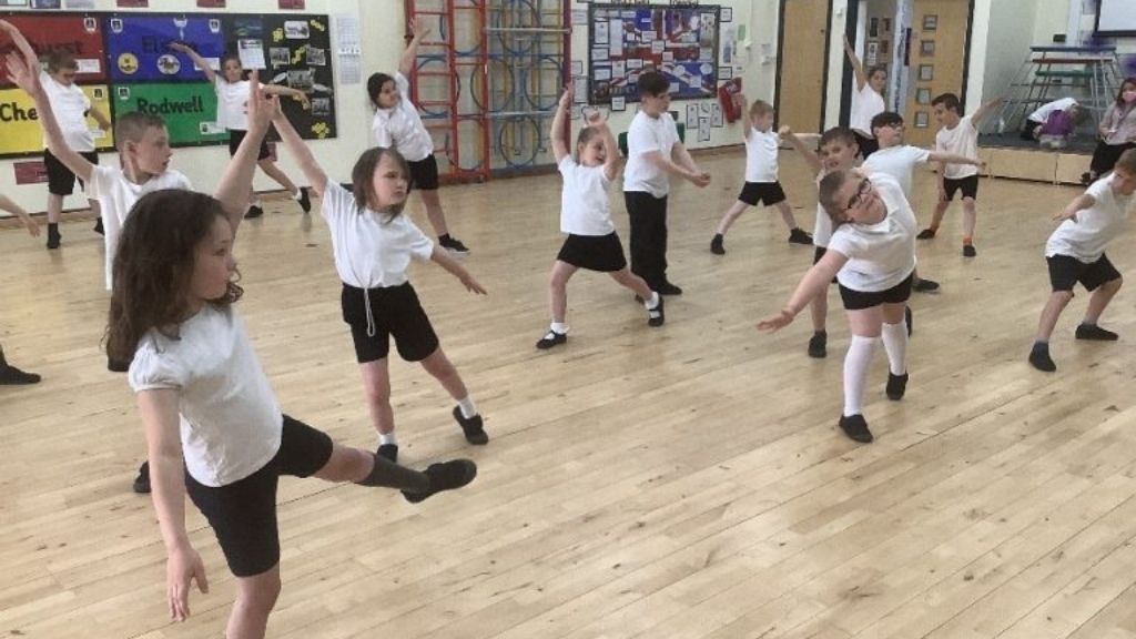 Primary steps students dancing in a school gym