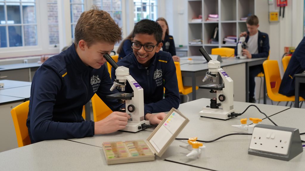 A new year at the school Two white lodge students in science class