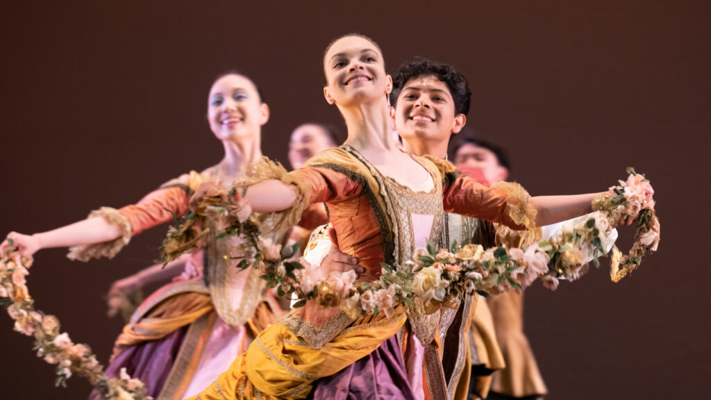 Dancers holding garlands perform the garland dance from the sleeping beauty