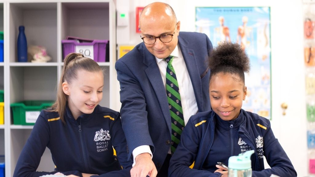 Our academic and pastoral principal with two students in a classroom.