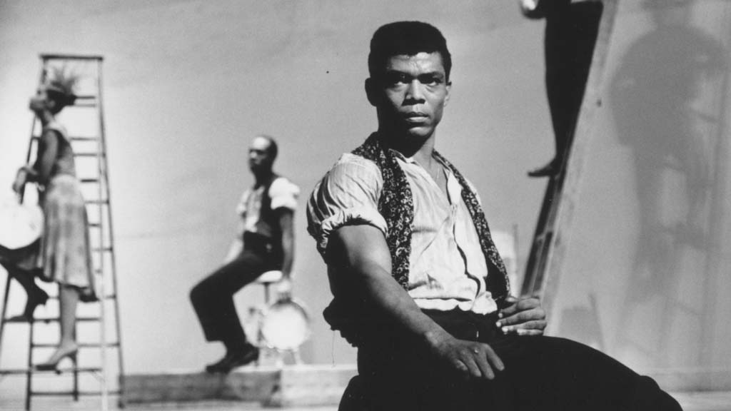 Alvin ailey in a black and white photograph on stage