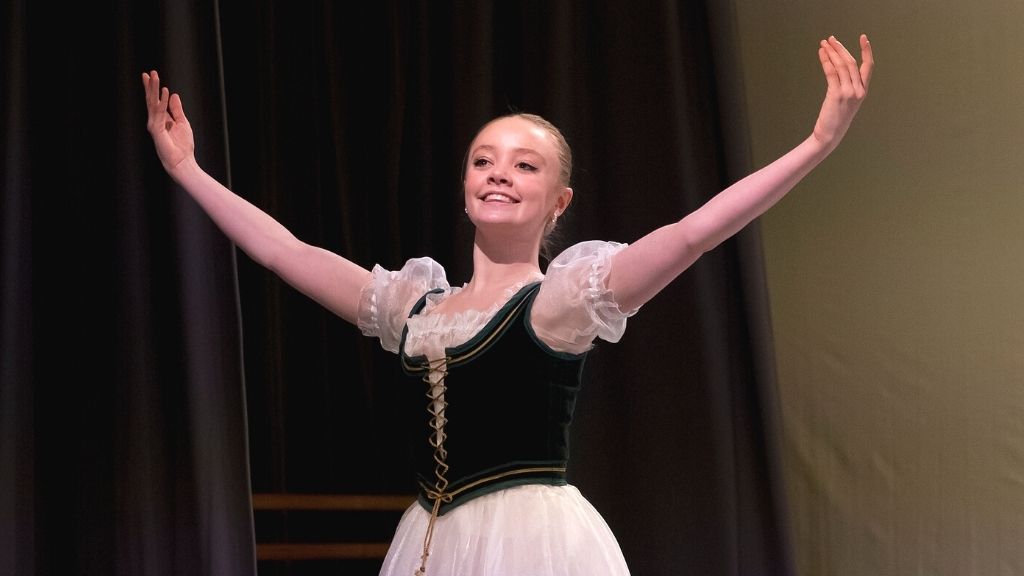 A student performing a solo variation wearing costume