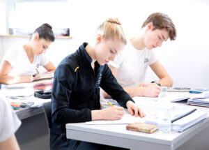 Students in class room writing