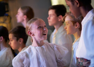 Student smiling backstage waiting to go on stage