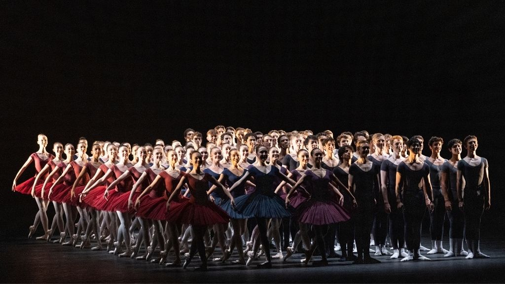 Students perform the défilé on the stage