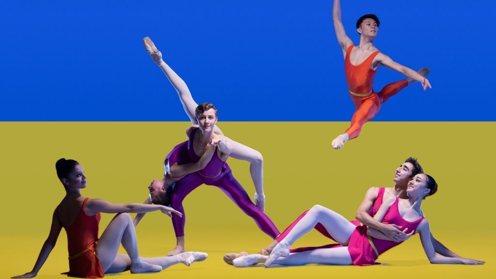 Students dancing in front of the flag of ukraine