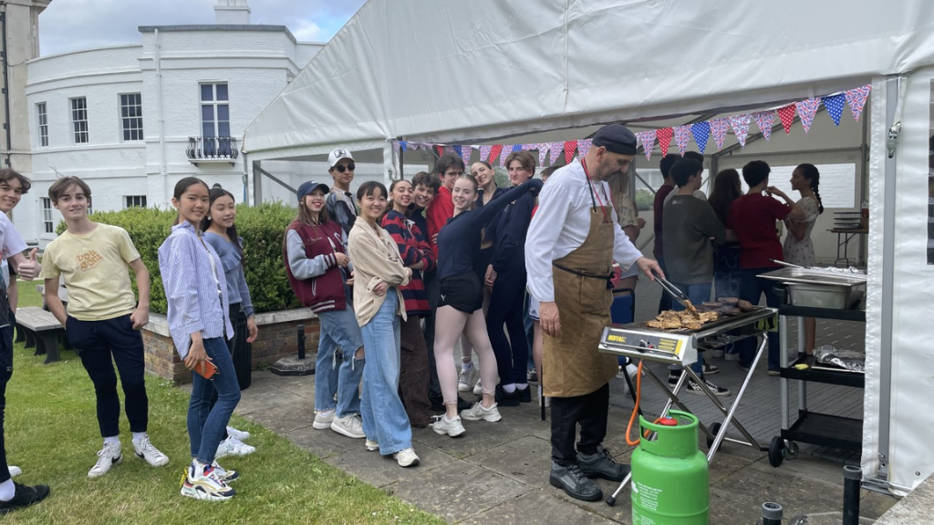 Students at a barbeque celebrating the queen's platinum jubilee