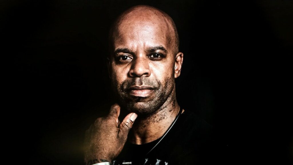 A head shot of denzil bailey on a black background