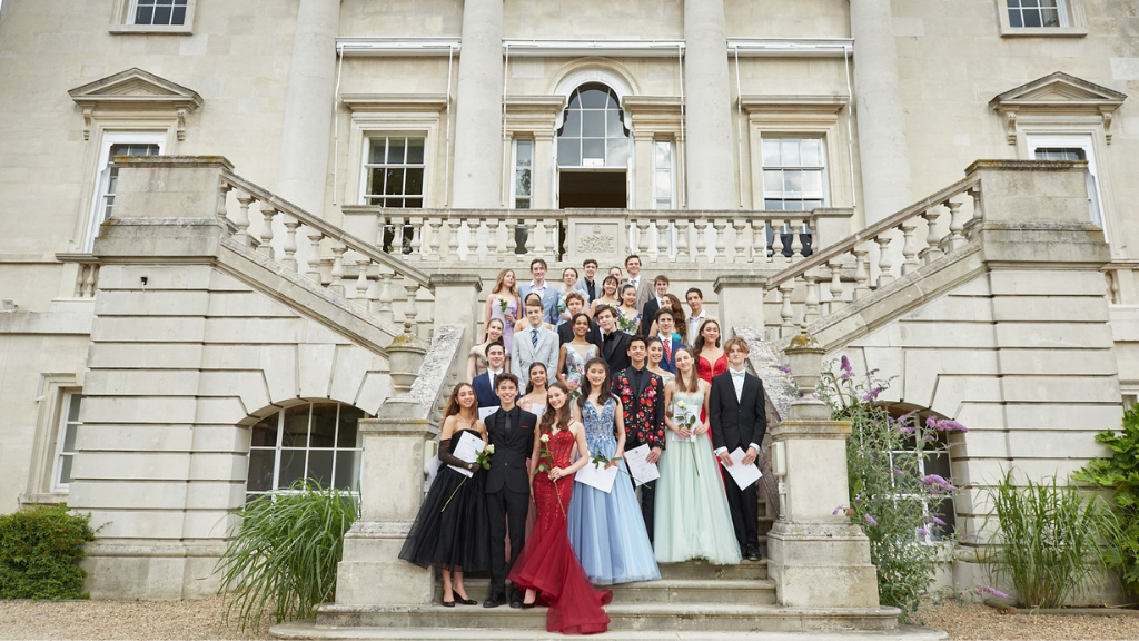 Year 11 students stand on the steps of white lodge at their celebration day