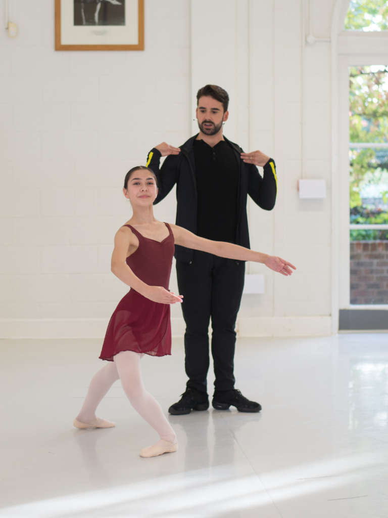 Image of student and teacher josé carayol in ballet class.