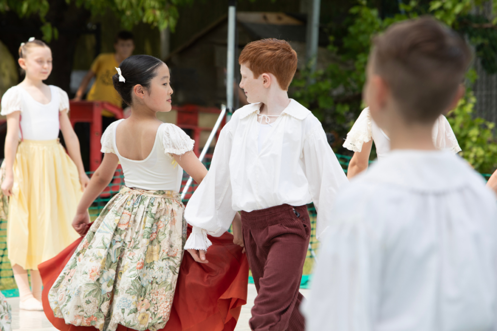 Junior associate students performing outdoors at a summer fair