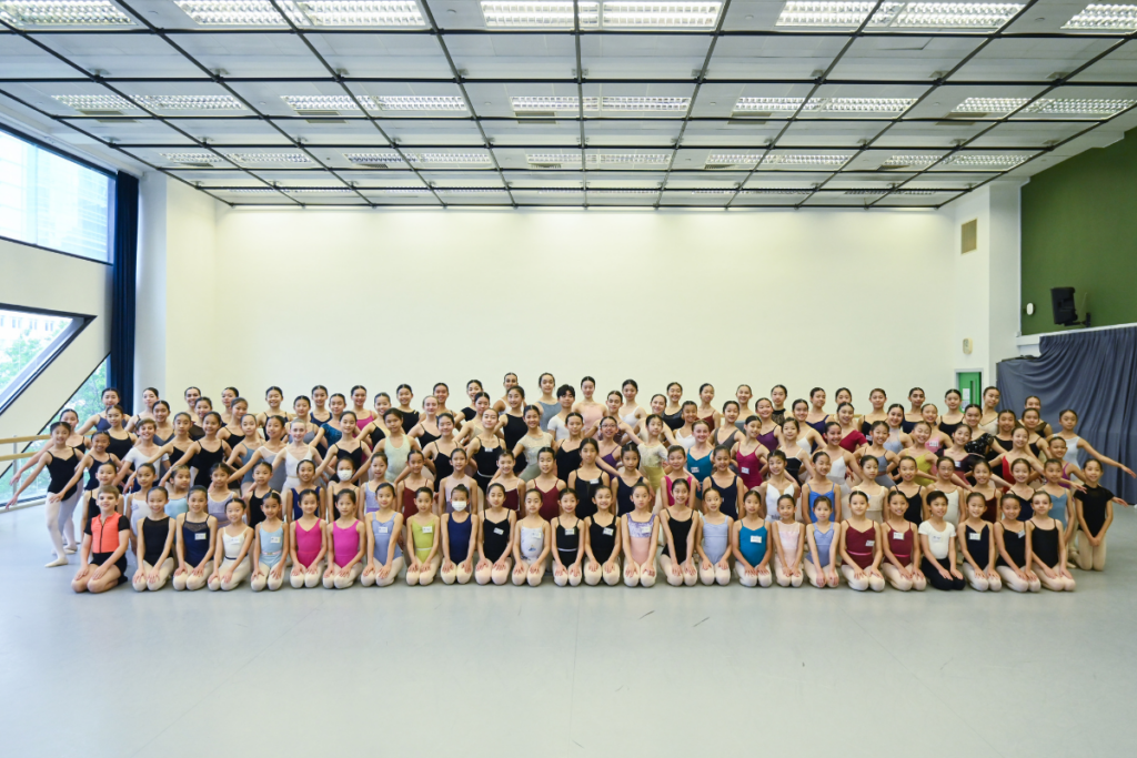 Large group of dancers smiling in a dance studio at hong kong intensive