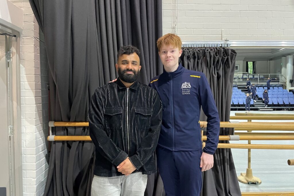 Hussain manawer standing with student after giving talk