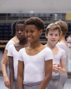 Uzziah smiling surrounded by friends