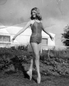 Susie's first steps on pointe, aged 12, at the end of 1st form (now year 7) at white lodge. She is pictured in a swimsuit and pointe shoes on the grass at a caravan site in pagham.