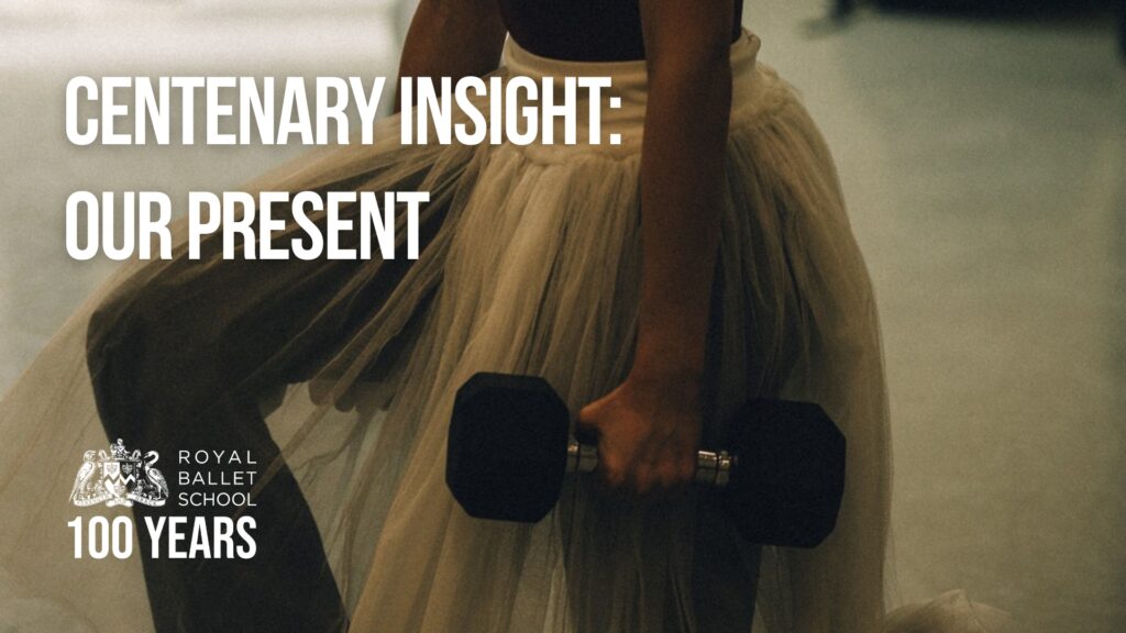 A dancer wears a white tutu over a dark leotard while holding a black dumbbell and lunging with her right leg forward. The photo is cropped at the waist.