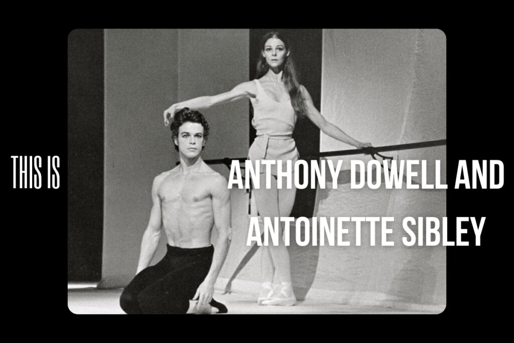 100 stories - anthony dowell and antoinette sibley Anthony kneels on both legs sitting back on his feet wearing black tights with no shirt. He faces downstage right with his head towards the audience. His arms hang by his sides. Antoinette stands beside him, one hand on a barre and the other a la seconde. She wears a loose white tunic with her hair down. She also faces the audience.