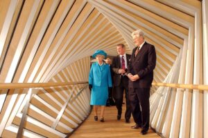 Queen elizabeth ii, david norman (centre) and sir colin southgate cross the bridge of aspiration following the official opening of upper school on 27 march 2003.