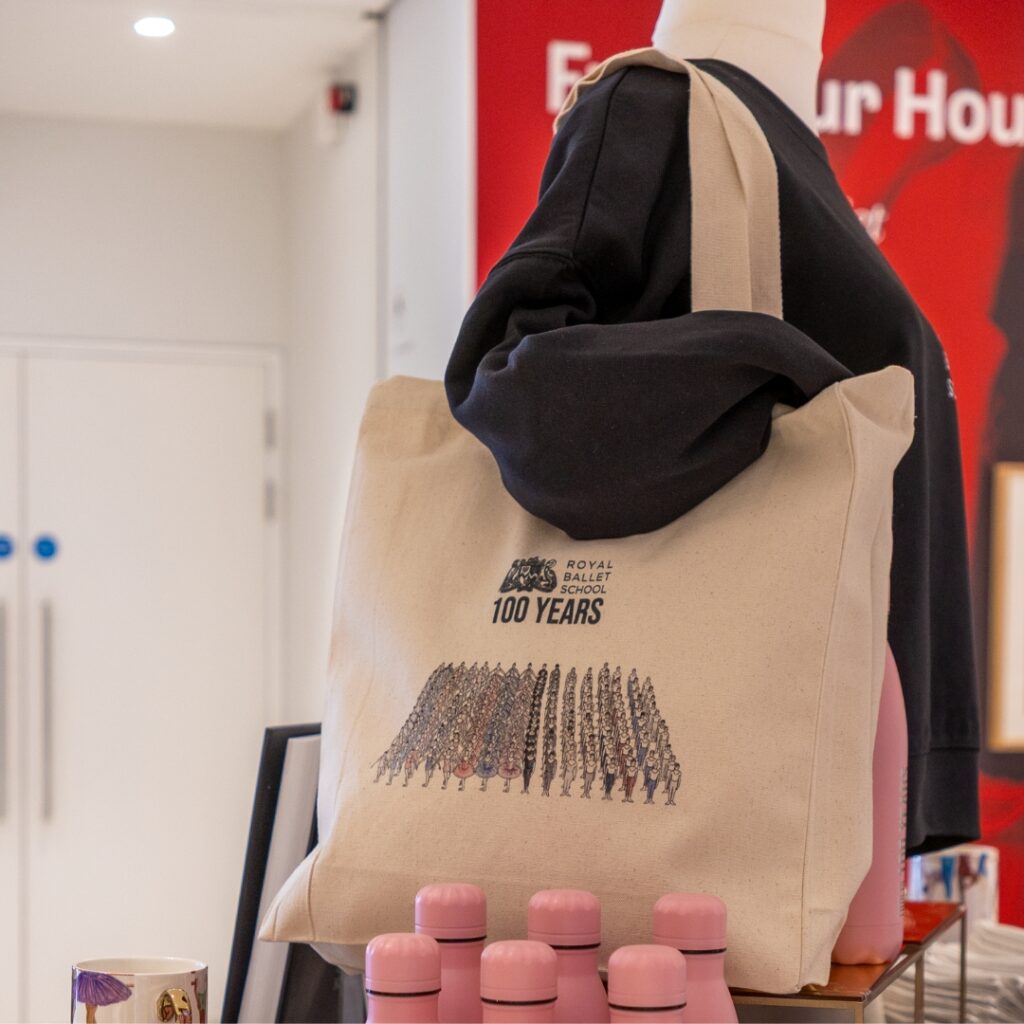 Behind the designs with centenary collection illustrators aimee tregunno and catja christensen A close up of the grand défilé tote bag on a mannequin.