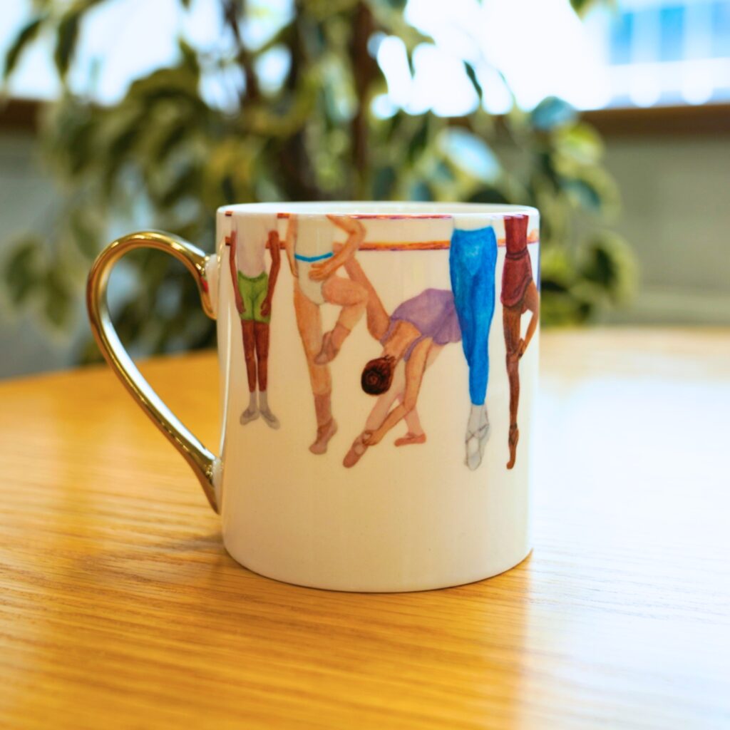 Behind the designs with centenary collection illustrators aimee tregunno and catja christensen A close up of the through the years mug, featuring watercolour paintings of students in uniform.