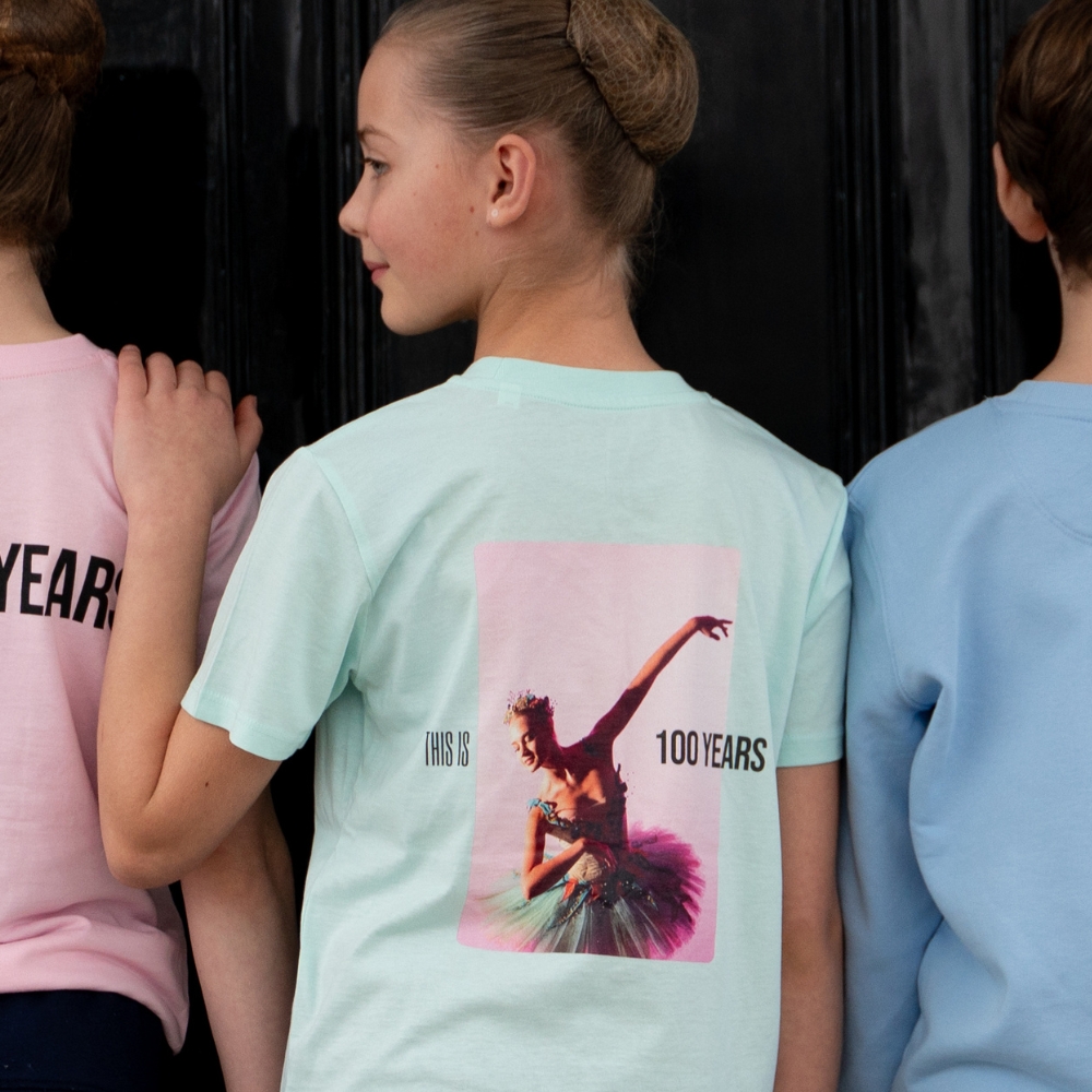 Fairy centenary children's t-shirt Product image of 'centenary performance children's t-shirt' in mint. Worn by a royal ballet school student at white lodge. A collection of merchandise in celebration of 100 years of the royal ballet school.
