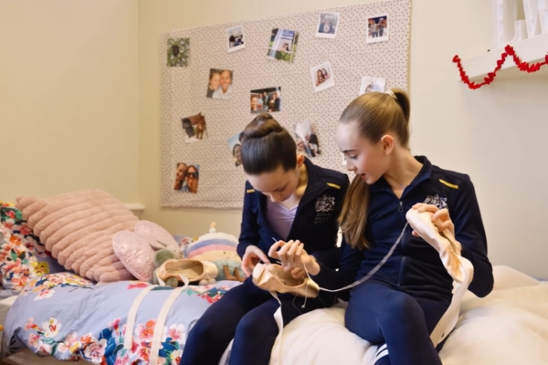 A day in the life of a full-time student at the royal ballet school White lodge girls sew pointe shoes on their bed.