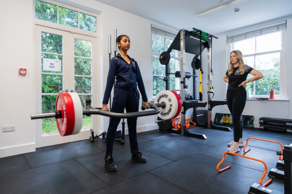 A day in the life of a full-time student at the royal ballet school A white lodge student lifts a barbell in the gym under the supervision of healthcare staff