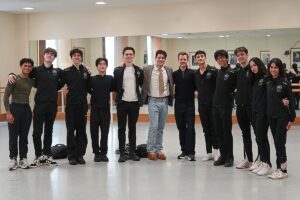 Jovani furlan stands with upper school students wearing school tracksuits in the studio after giving a creative artist talk